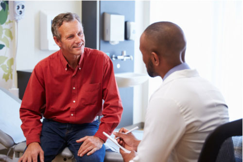 Smiling man and doctor concept of cancer pain treatment in Greenville SC