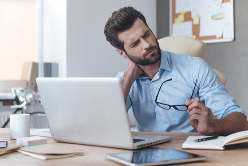 Young man with neck pain concept of neck pain treatment in Spartanburg SC