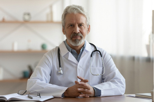 Mature doctor concept of treatment for degenerative conditions in Greenville SC